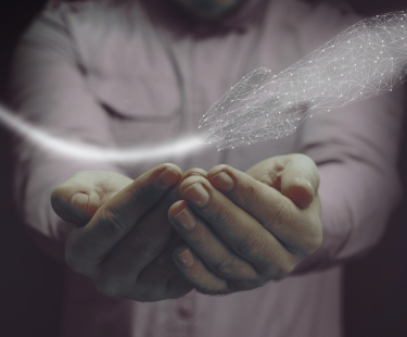A person holds out cupped hands beneath a digital wireframe rocket, symbolizing launching a new idea or innovation.