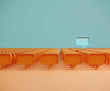 Illustration of many orange speech bubbles with one blue speech bubble standing out, symbolizing unique insights from school community surveys.