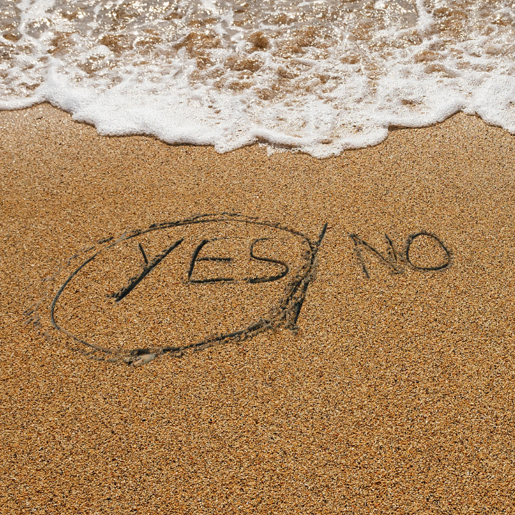 Yes/No written in the sand, with Yes circled