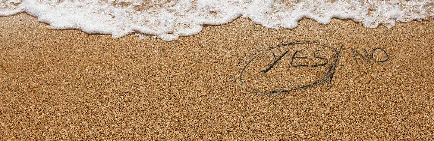 Yes/No written in the sand, with Yes circled