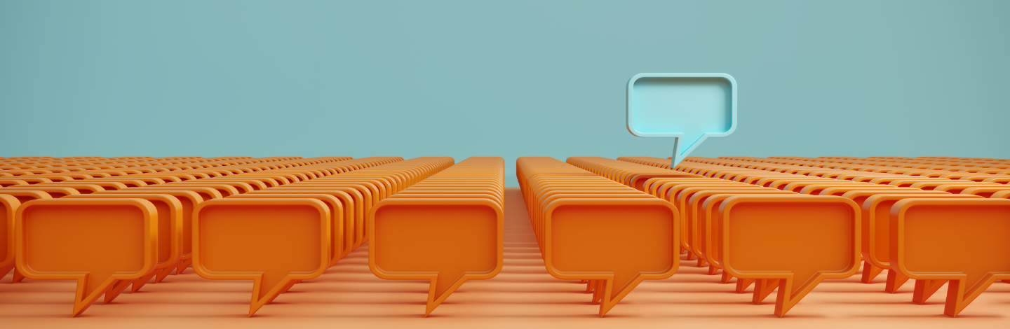 Illustration of many orange speech bubbles with one blue speech bubble standing out, symbolizing unique insights from school community surveys.