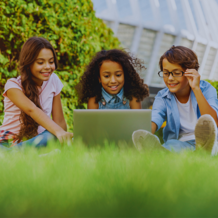 elementary-aged students outside, using tablets