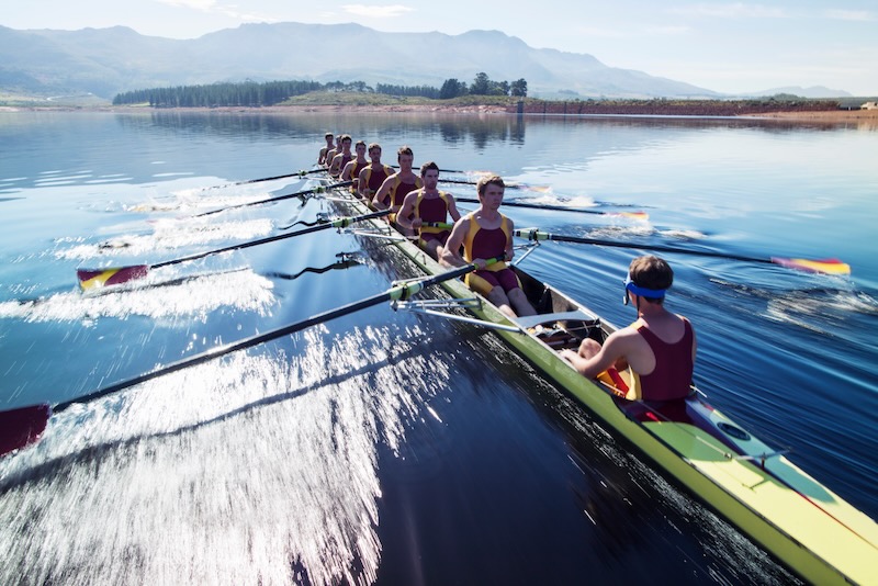 Rowing crew, led by coxswain keeping them in line